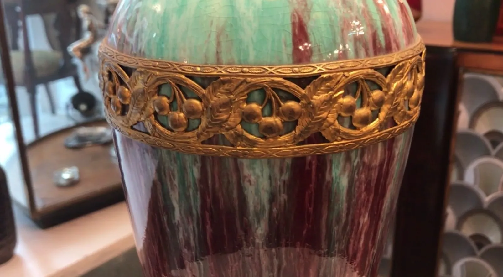 Antique ceramic vase with shiny golden details.
