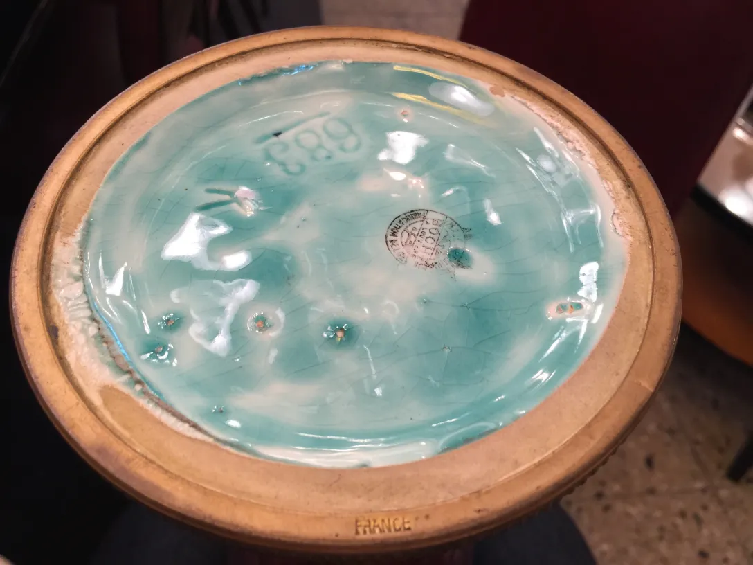 Antique ceramic bowl with a blue background and white details.
