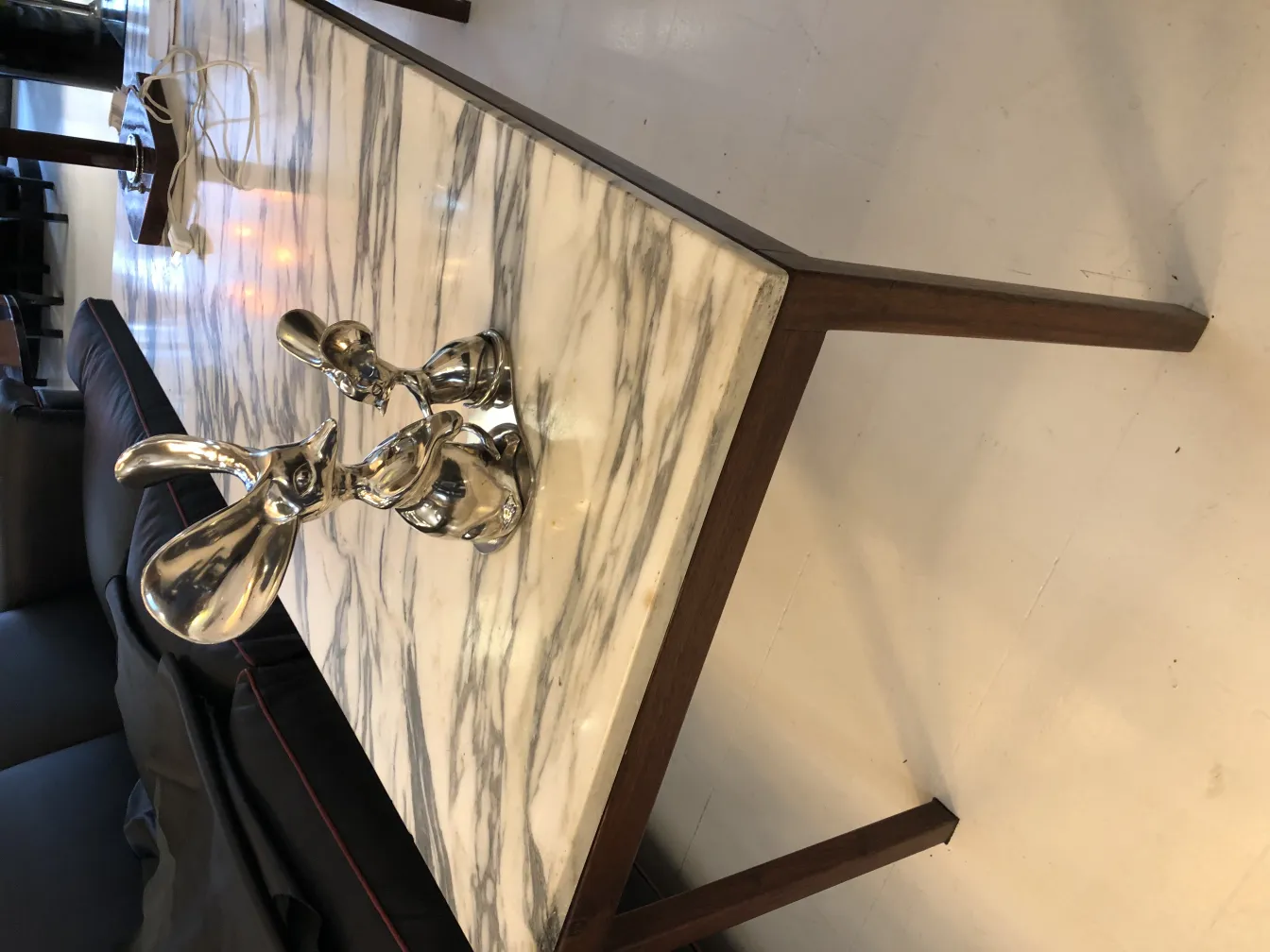 Antique rabbit sculpture on a marble table.