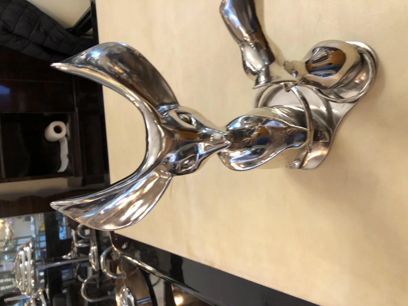 Antique sculpture of an abstract figure with shiny details