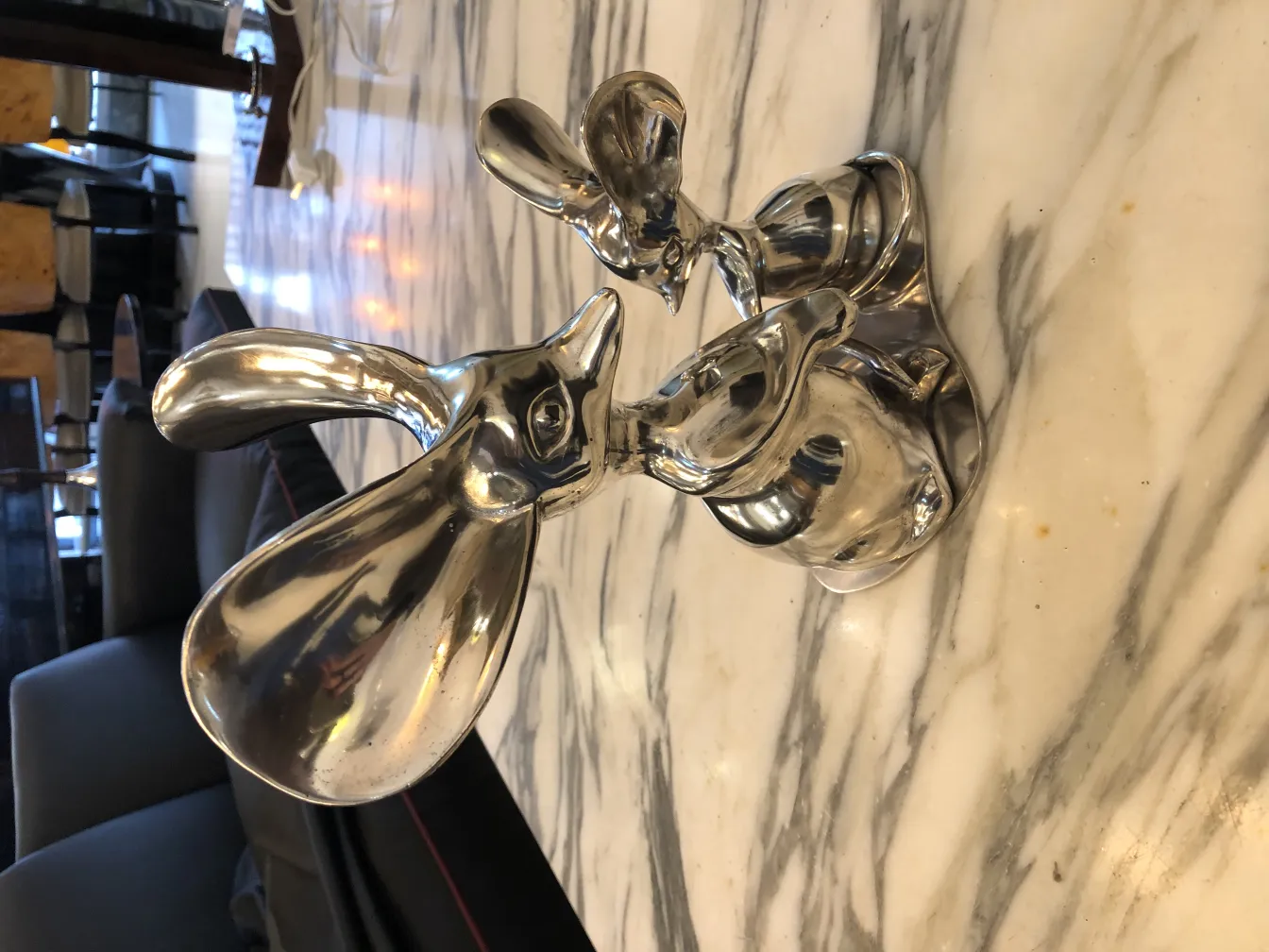 Antique sculpture of figures with shiny details.