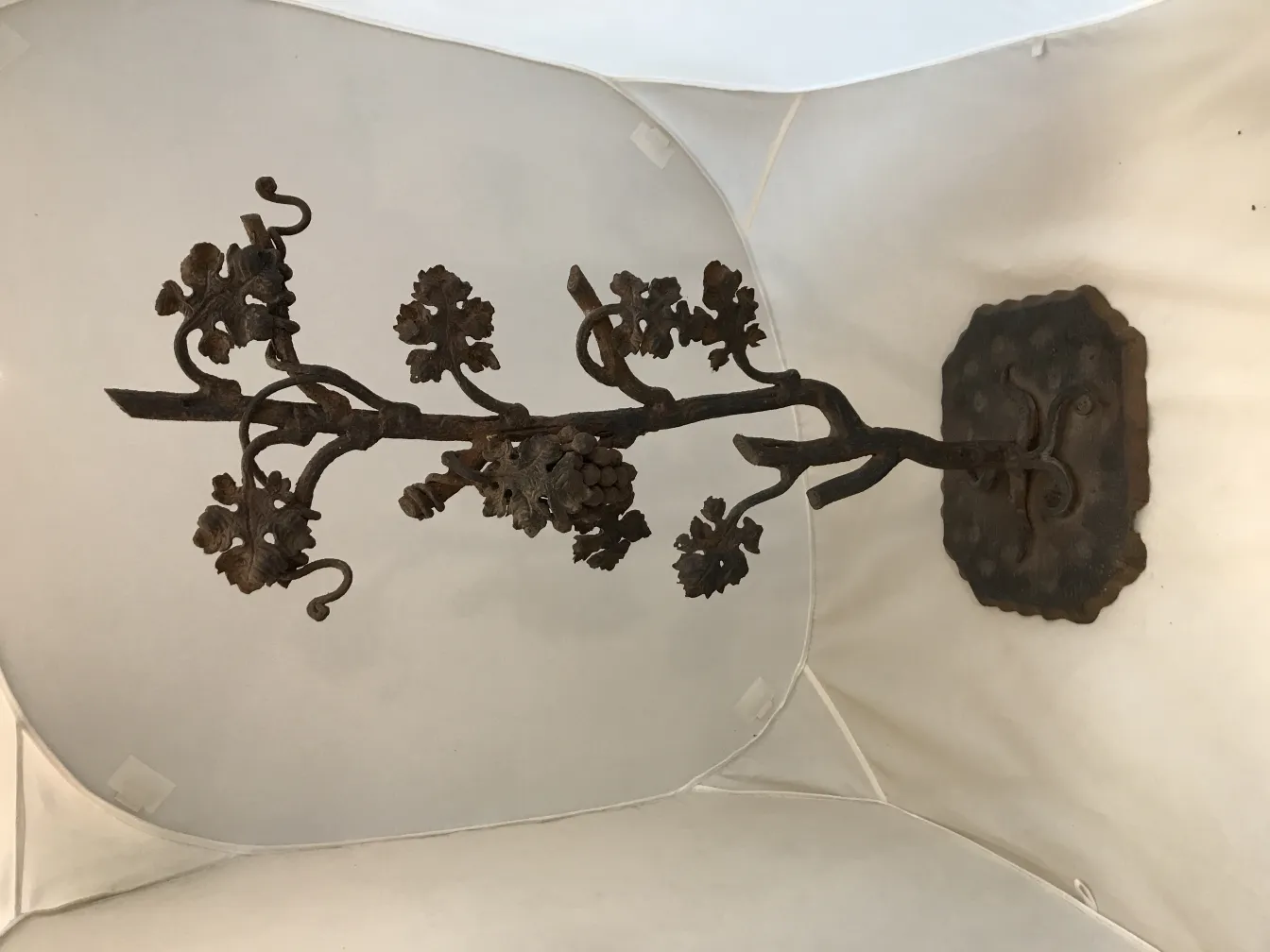 antique sculpture with branches and leaves on a base
