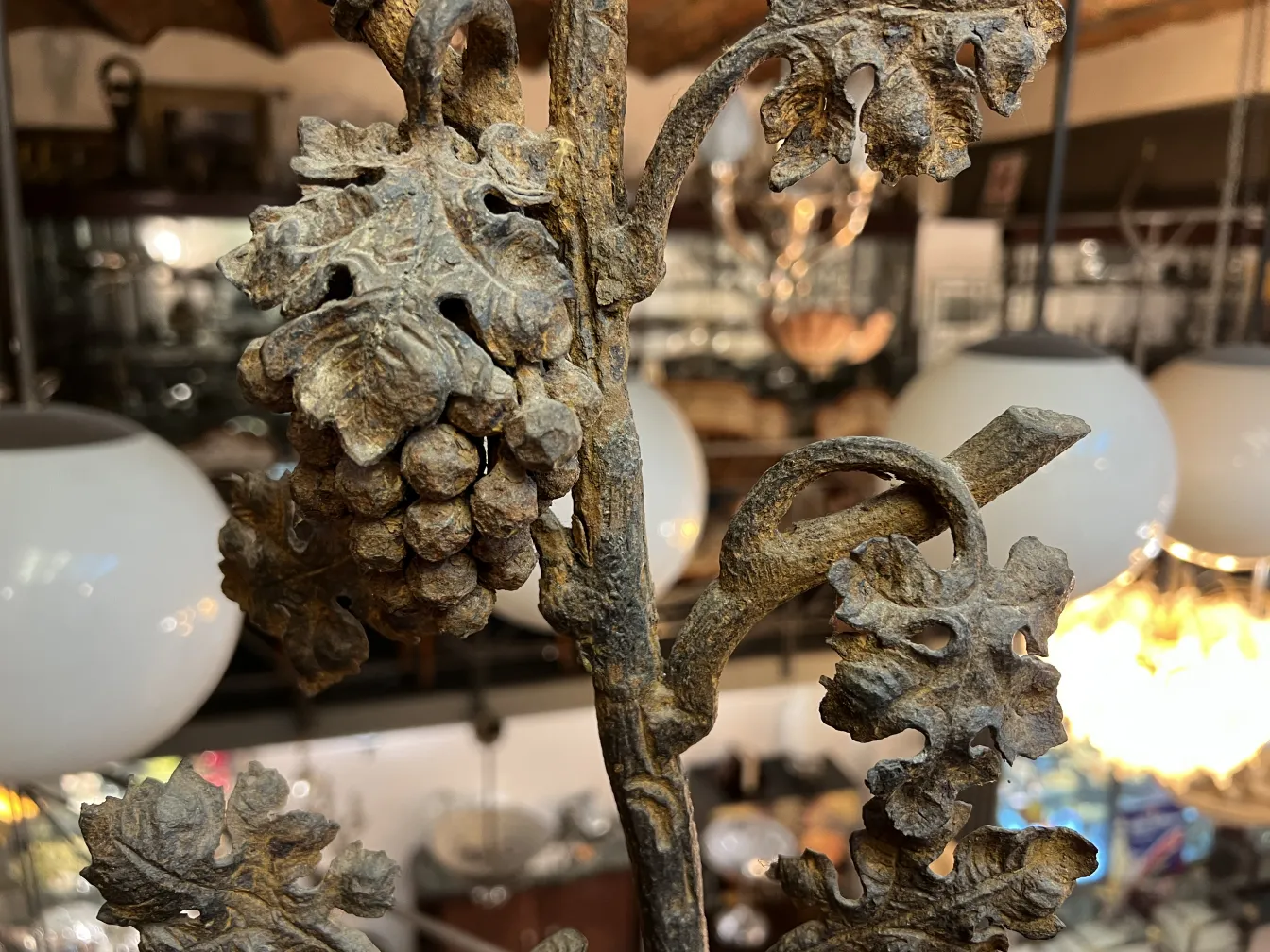 antique sculpture featuring detailed leaves and grapes in an elegant setting