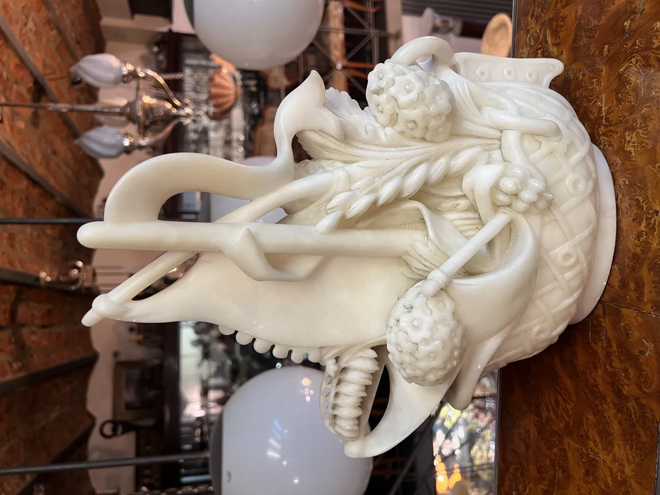 Antique sculpture featuring ornamental details and fine figures