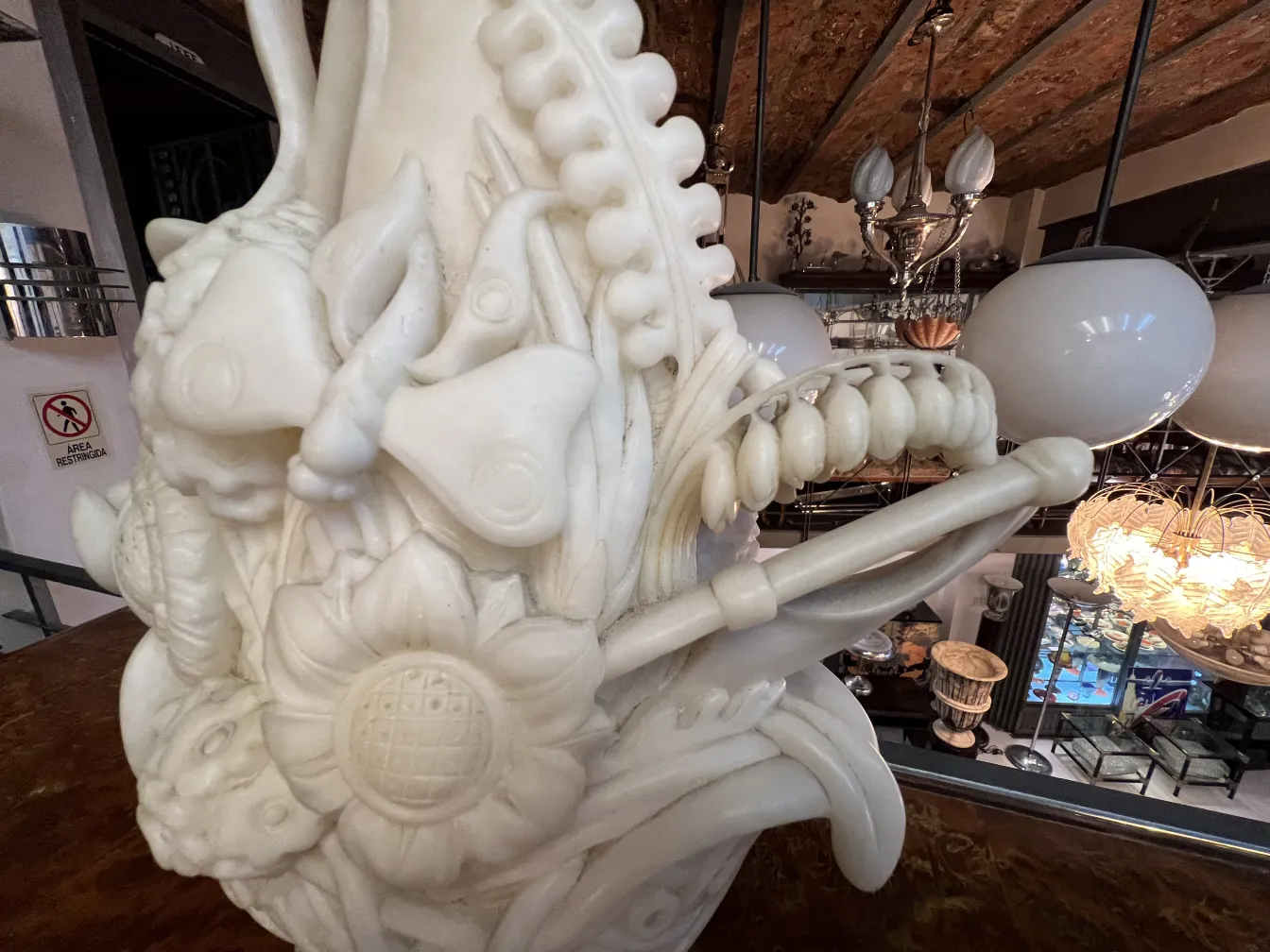 Antike Skulptur geschmückt mit weißen Blumen und Tieren