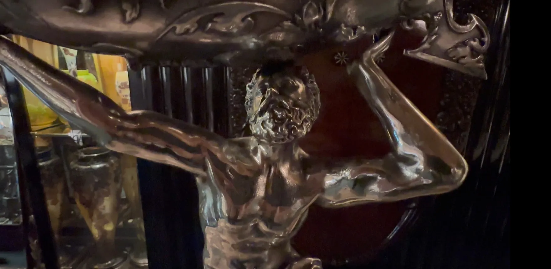 escultura antiga de figura muscular em um ambiente escuro