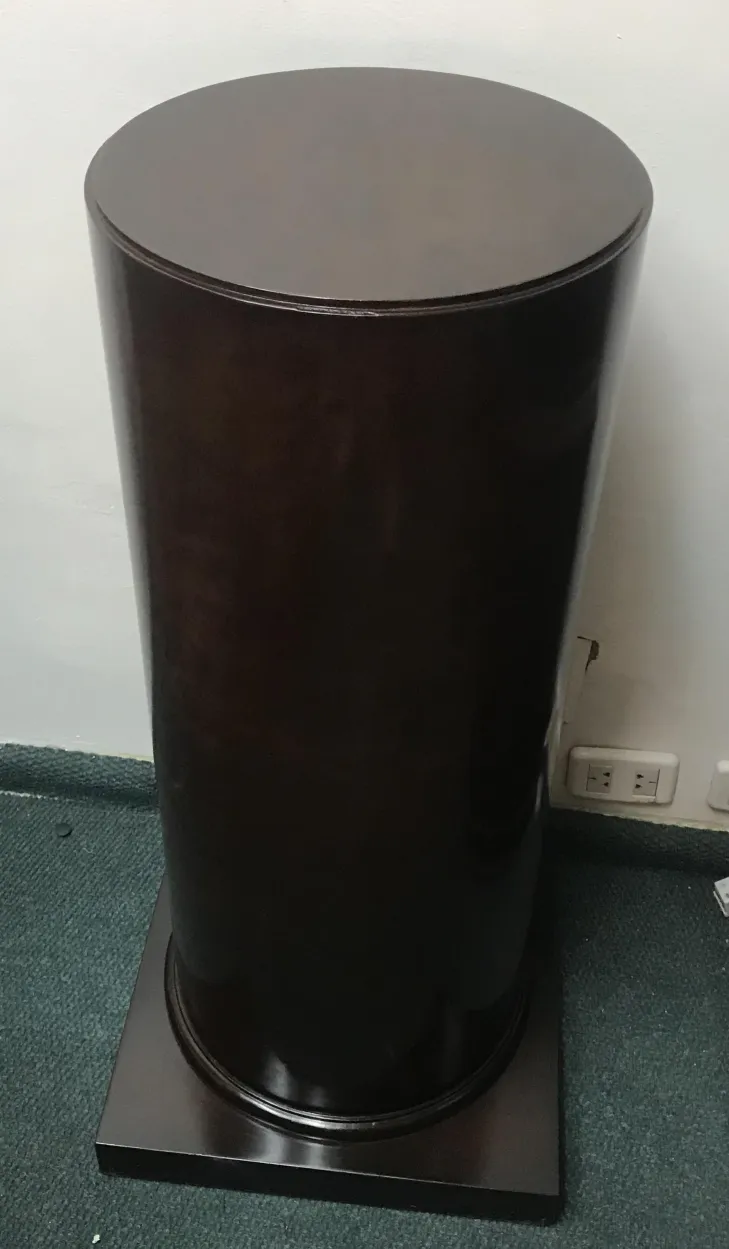 Corner of an antique column with a base, in a neutral setting.