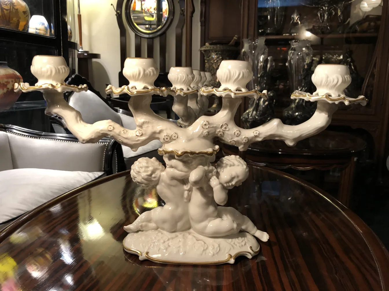 Antique ceramic candelabrum with angelic figures