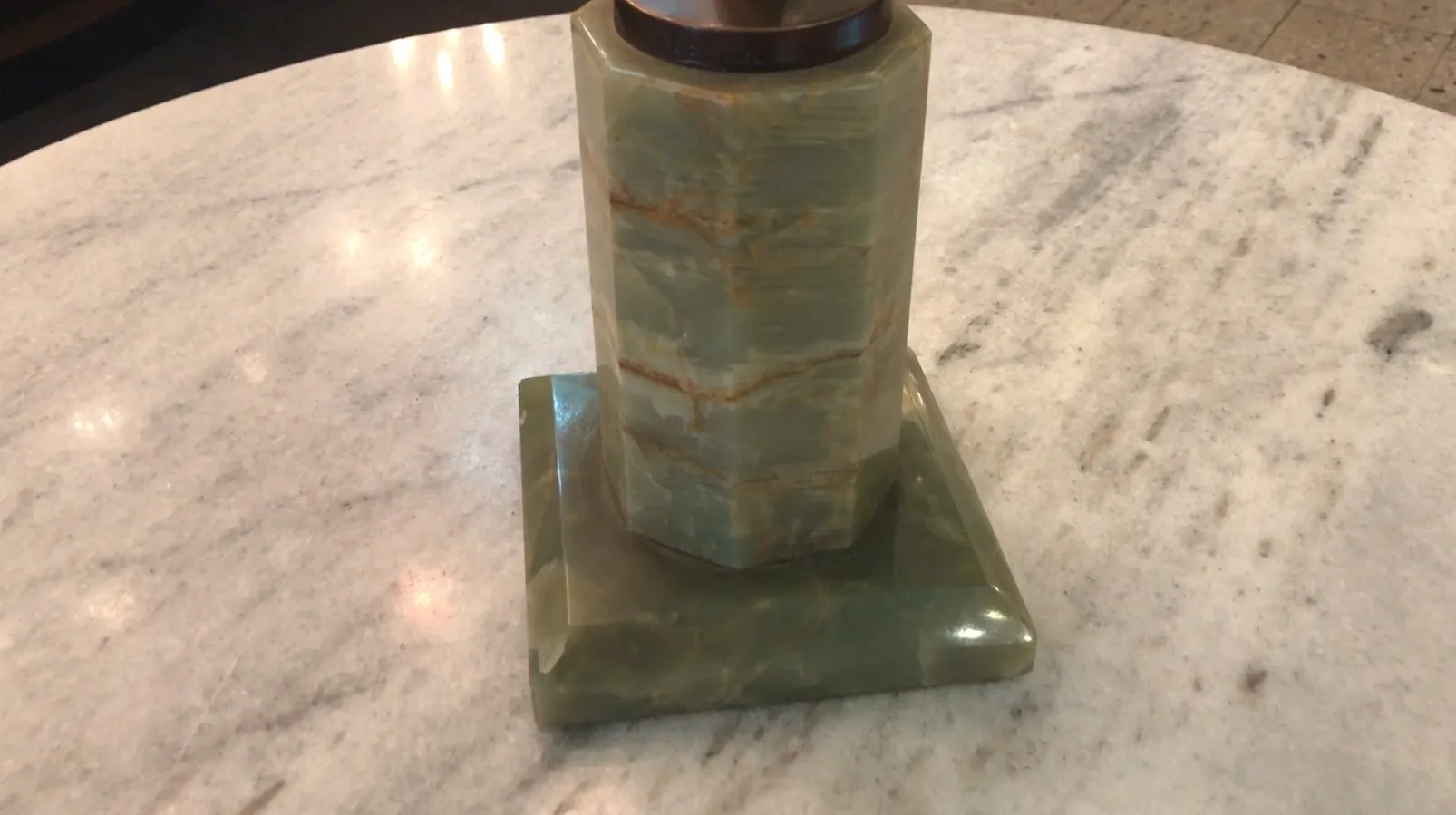 Escultura antigua de jade con base verde en mármol, elegante y sofisticada