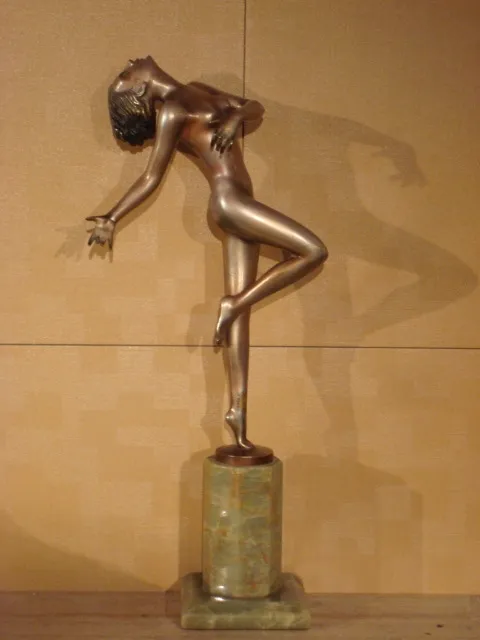 Antique sculpture of a female figure dancing, bright bronze.