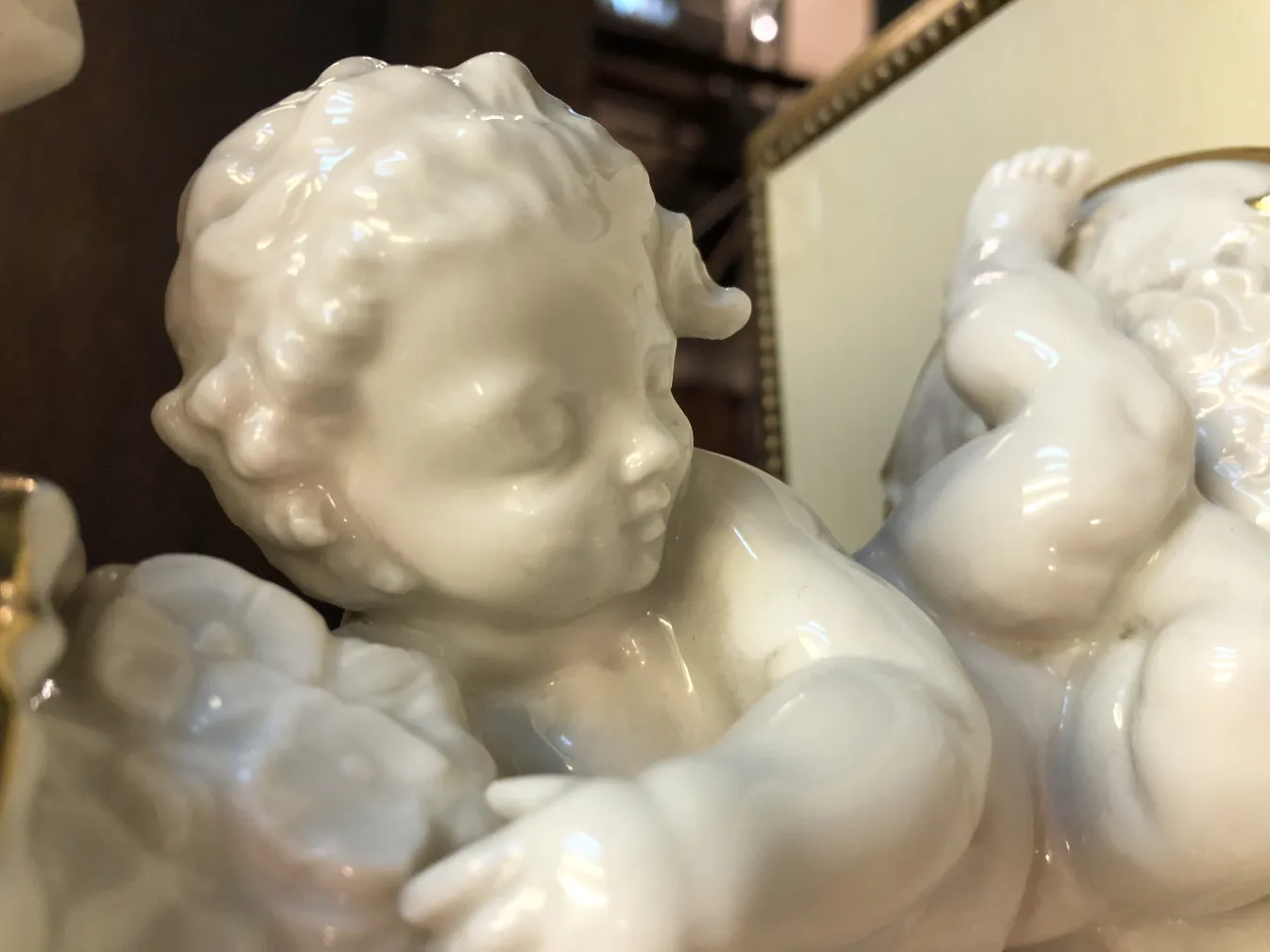 Antique ceramic of a cherub with floral details