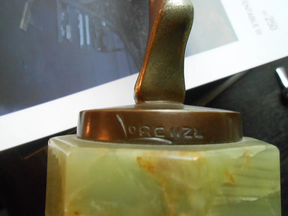 Antique sculpture by Lorenzo with decorative green base.