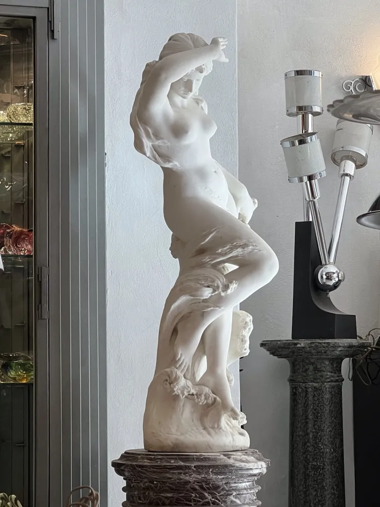 Beautiful antique sculpture depicting a female figure, elegantly set in the background.