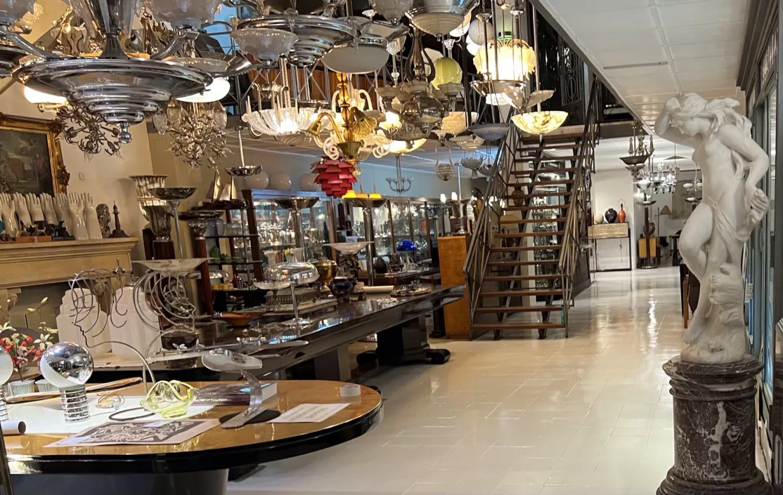 antique sculpture a. piazza in a well-lit gallery surrounded by decorative items