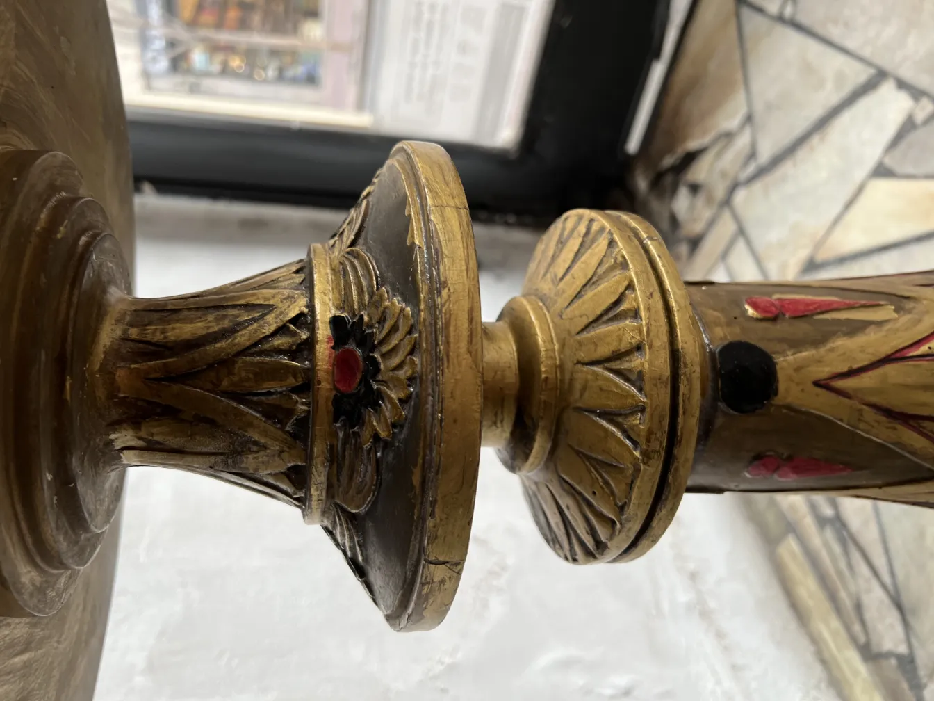 Antique sculpture adorned with colorful details, classic environment.