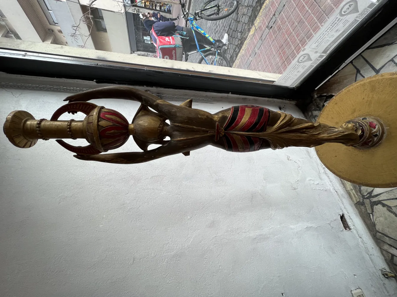 Antique sculpture with golden and red details, elegant.