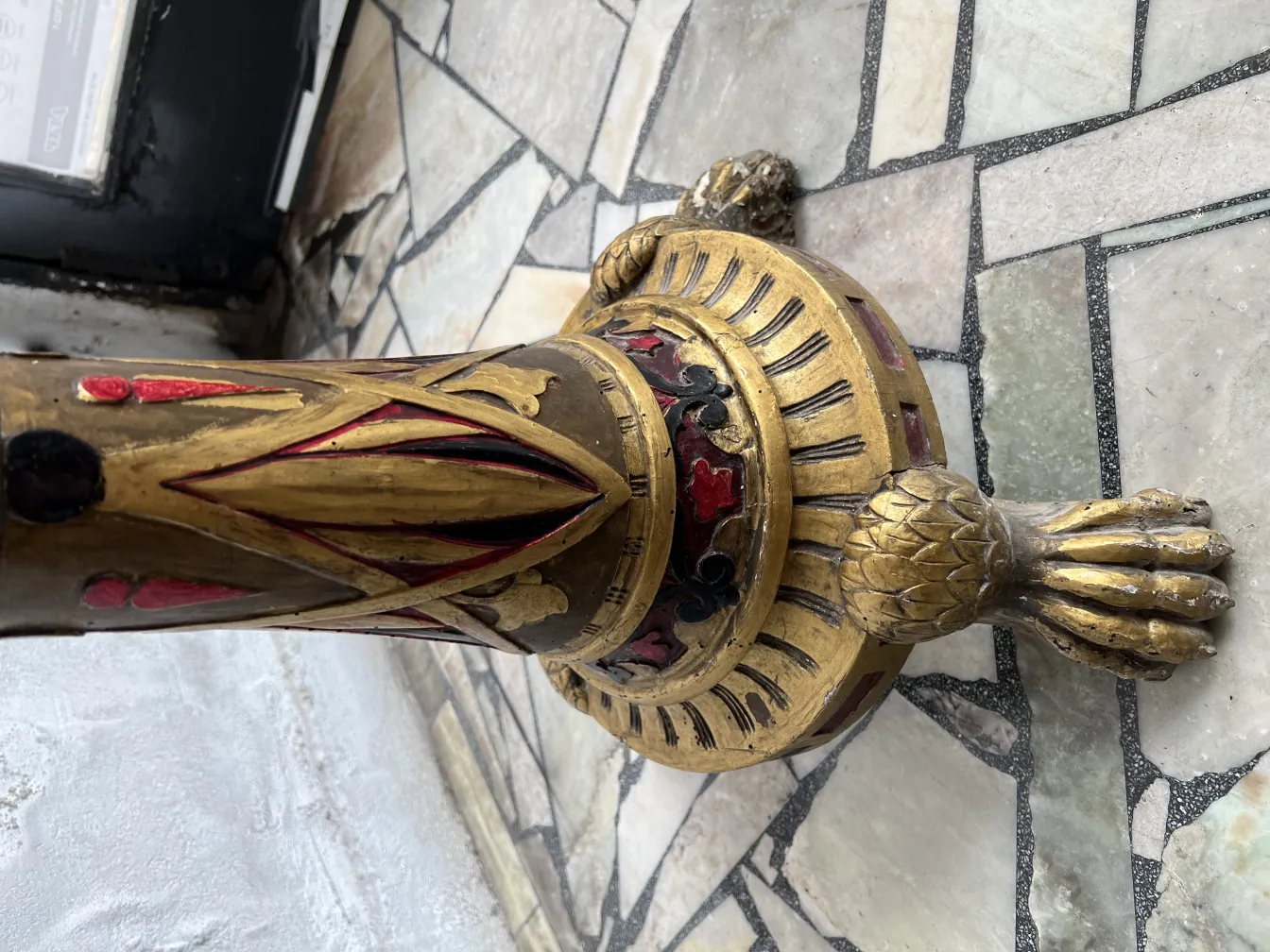 Antique sculpture with carved ornamental details on the base.