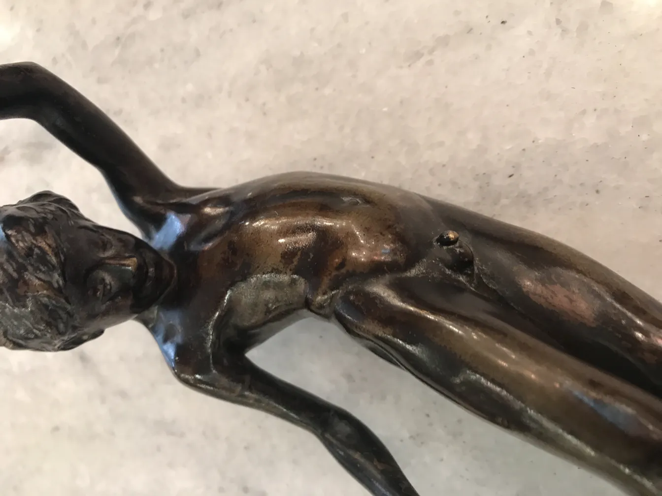 Antique sculpture of a human figure with intricate details, expressive and elegant.