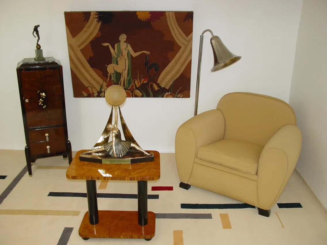 Antique Art Deco sculpture featuring a female figure and sun