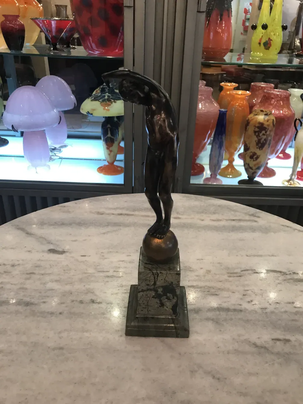 ancient sculpture of male figure on base