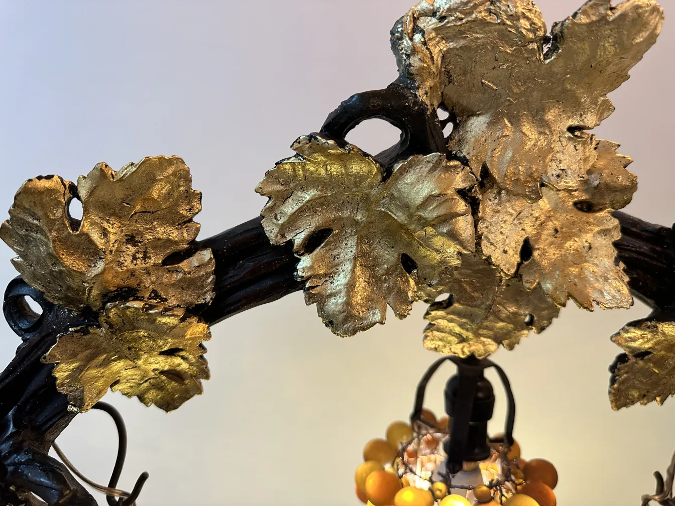 Details of an antique sculpture featuring golden leaves in artistic style.