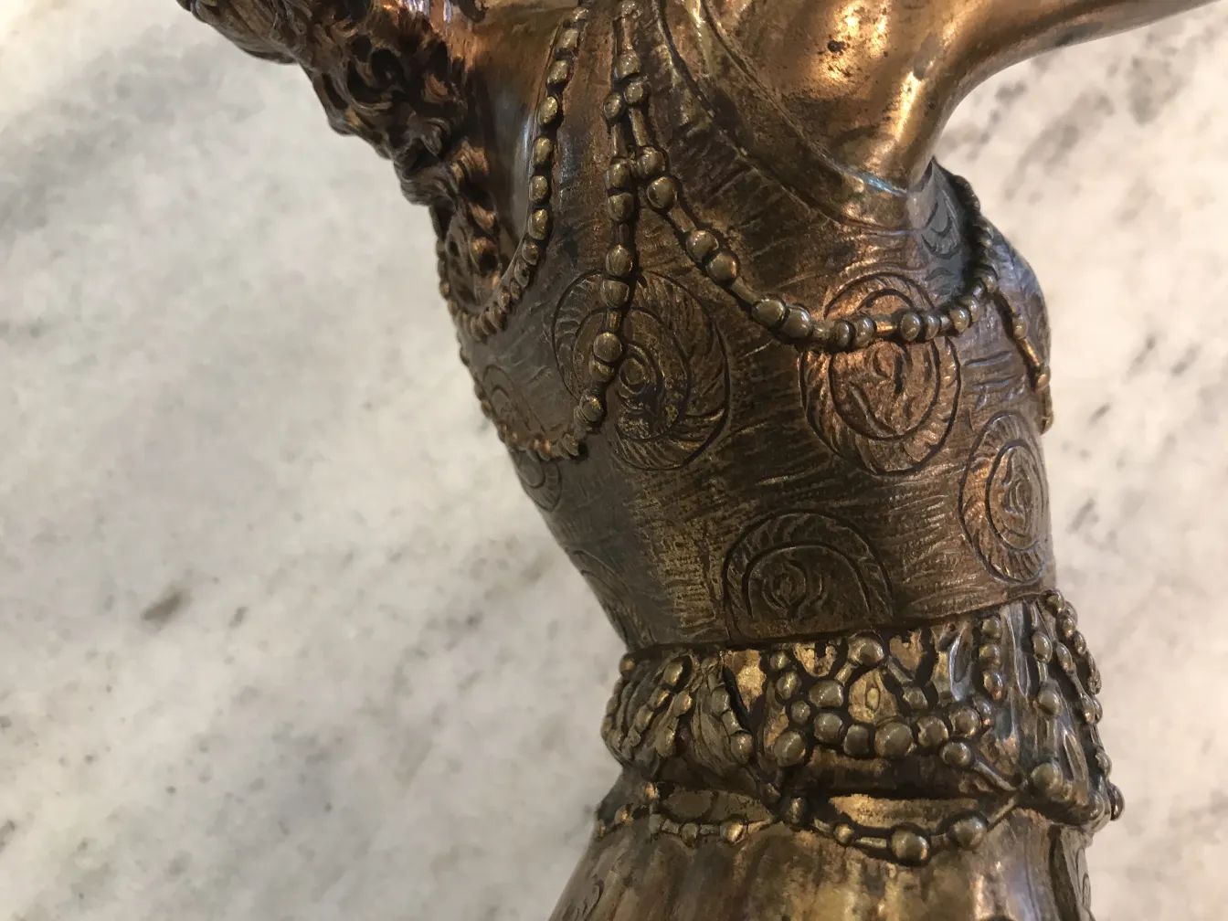 Antique sculpture featuring intricate decorative details.