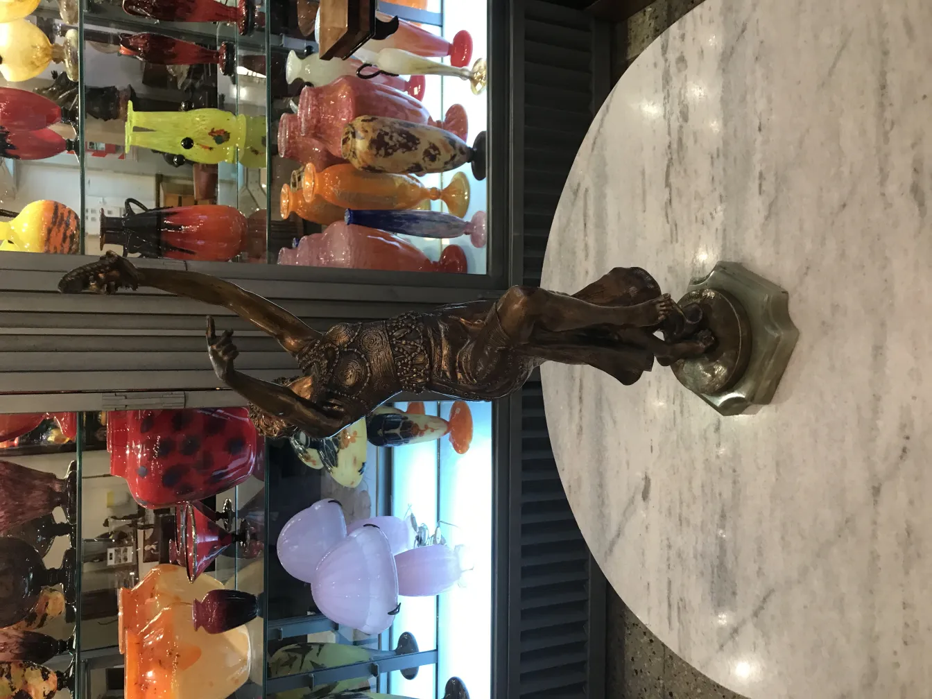 Antique sculpture of a human figure in an elegant pose.