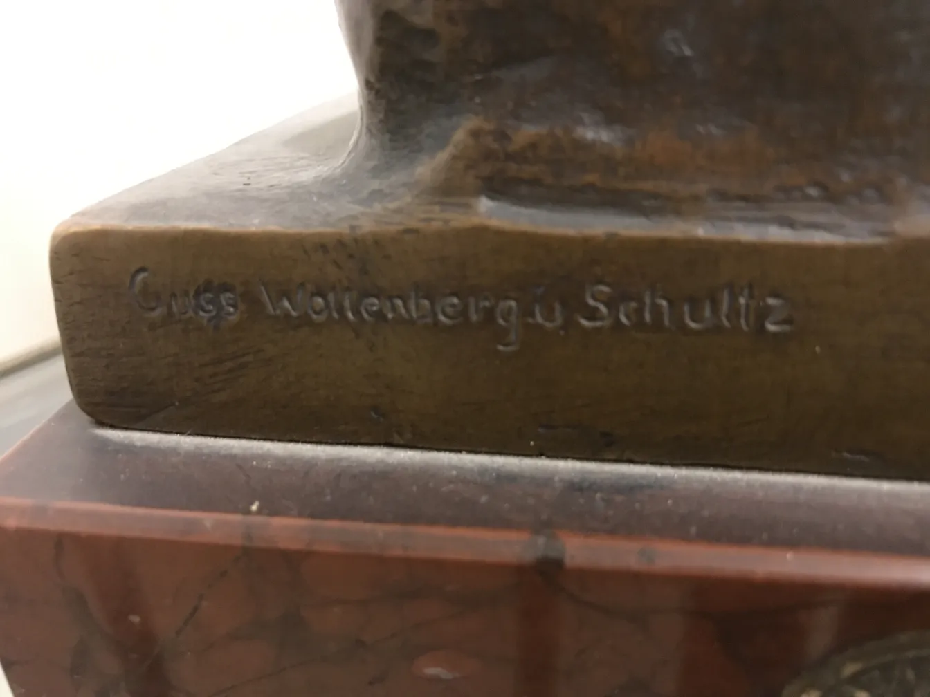 antique sculpture with visible details, signature on base.
