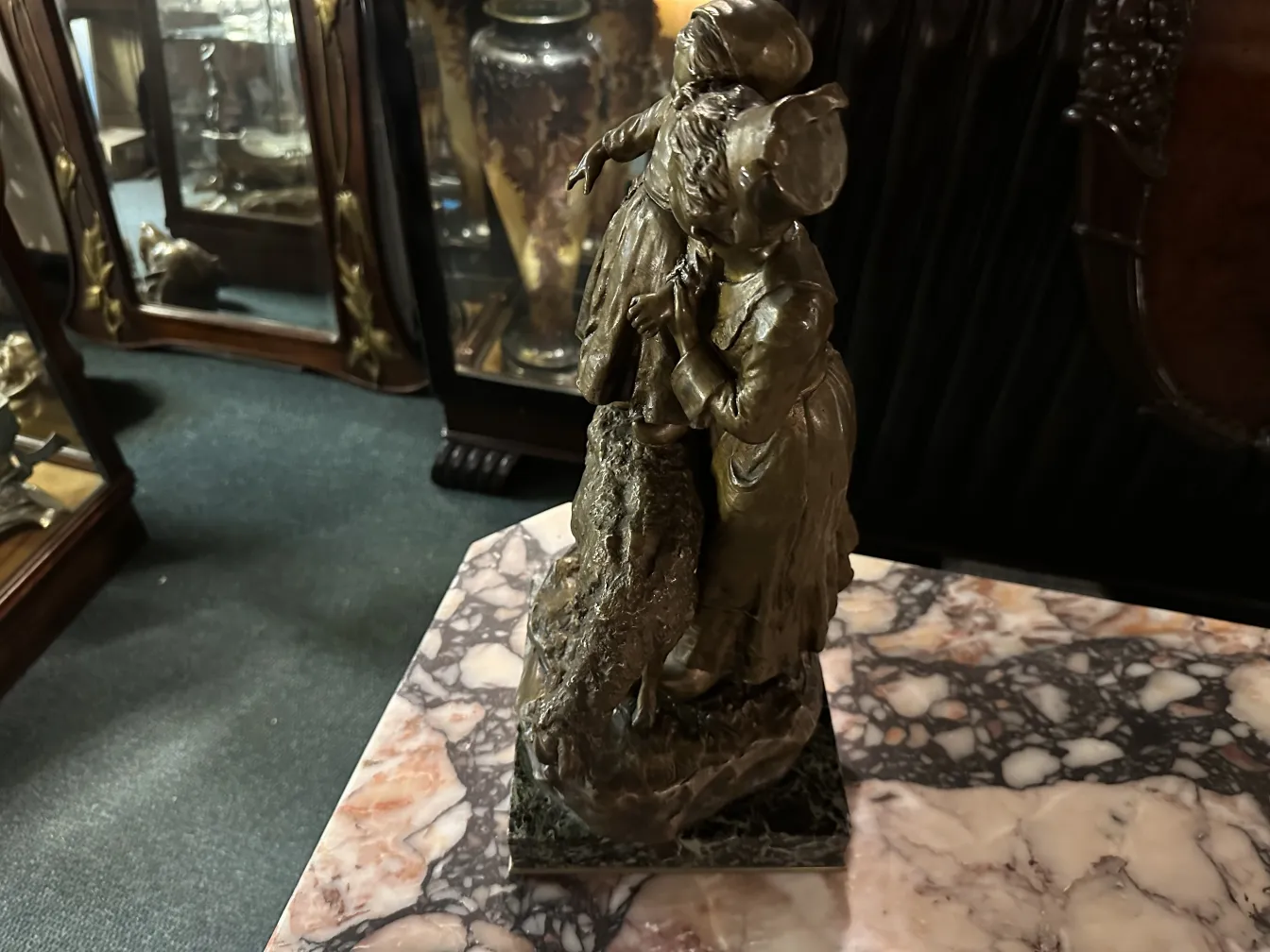 sculpture ancienne de deux figures dans un cadre classique