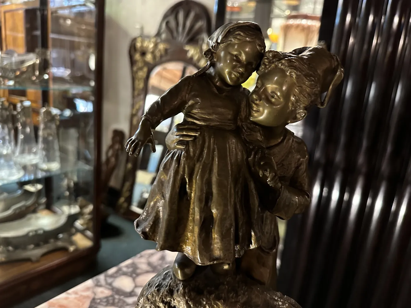 antique sculpture of embracing children in a cozy setting