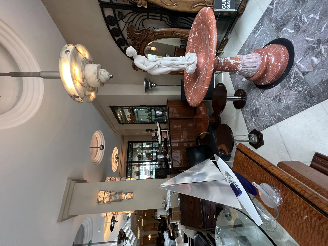 escultura antiga elegante com base redonda e detalhes decorativos em um ambiente antigo