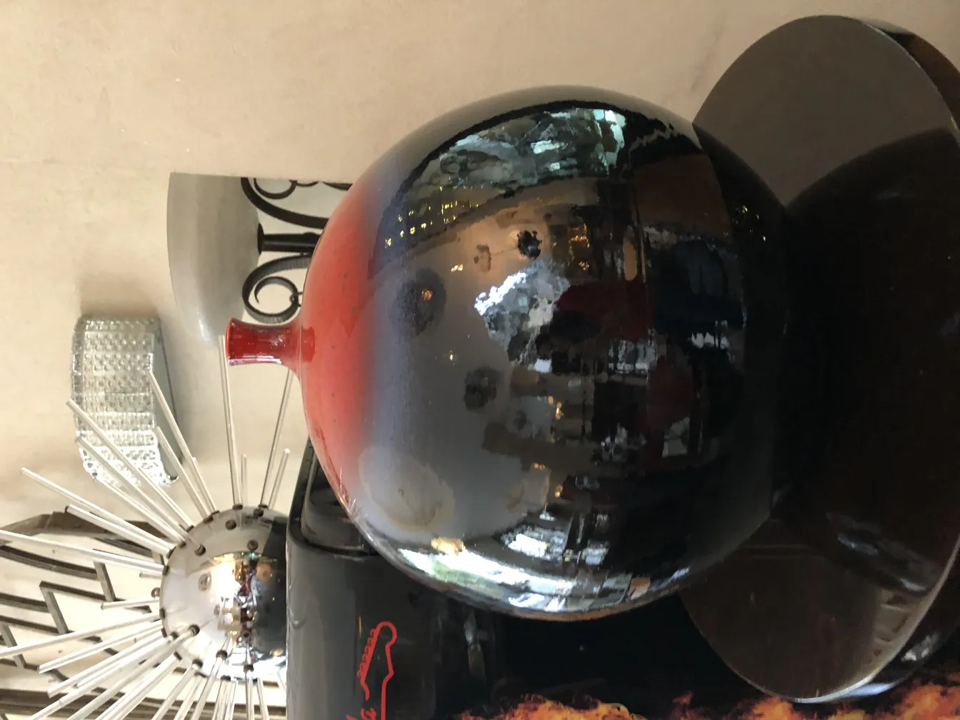 Antique ceramic vase with purple and red tones, bright reflections.