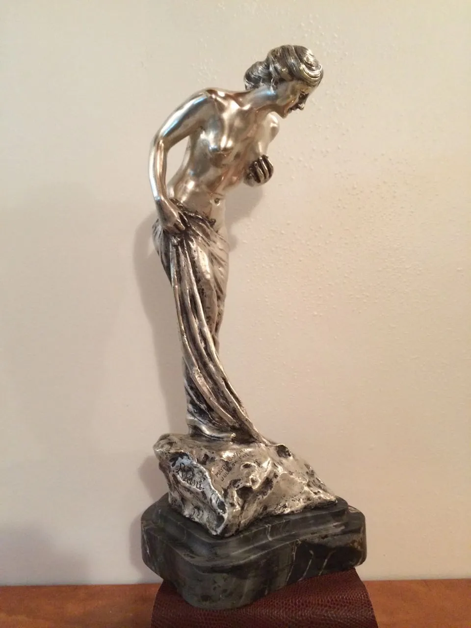 antique sculpture of a female figure with details