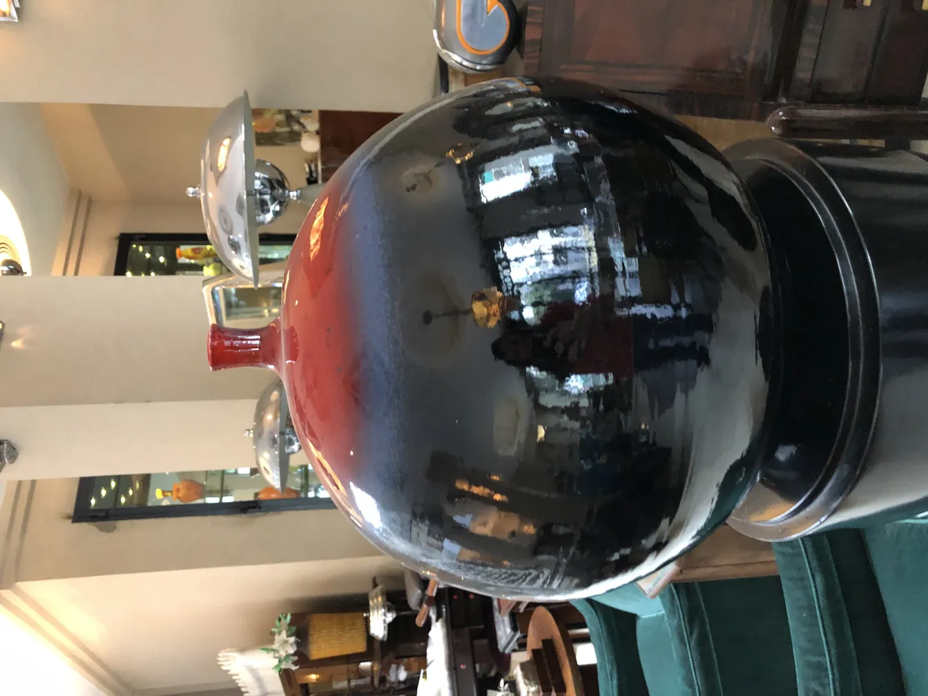 Esfera negra con detalles rojos, reflejos brillantes.