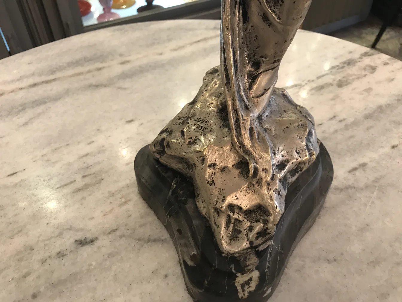 Antique sculpture with decorative base, elegant shapes and intricate details