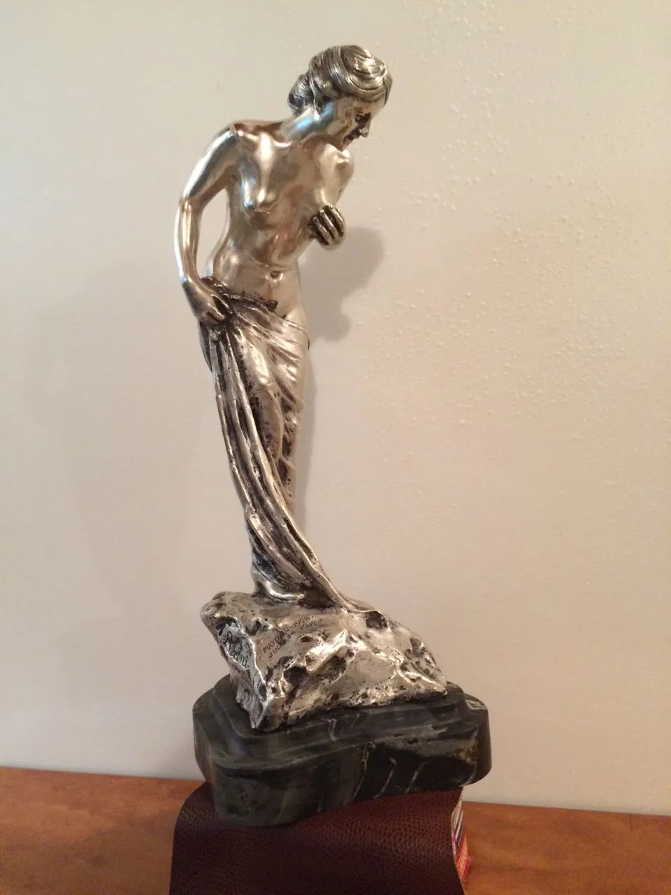 ancient sculpture of female figure with detailed drapery