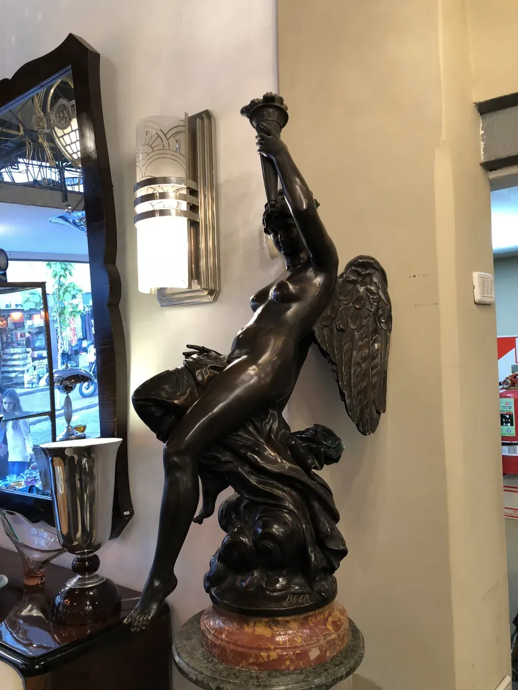 Antique sculpture featuring a female figure with wings, Beer.