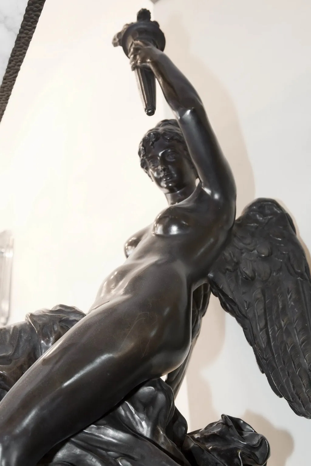 ancient sculpture featuring a female figure with wings