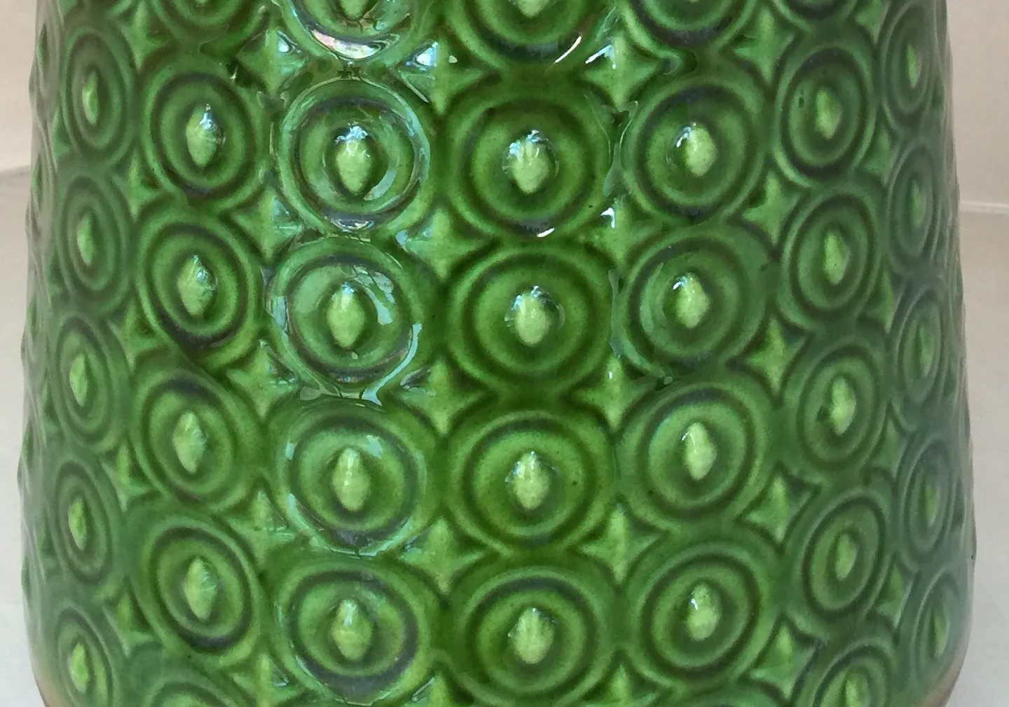 decorative antique green ceramic with circular patterns