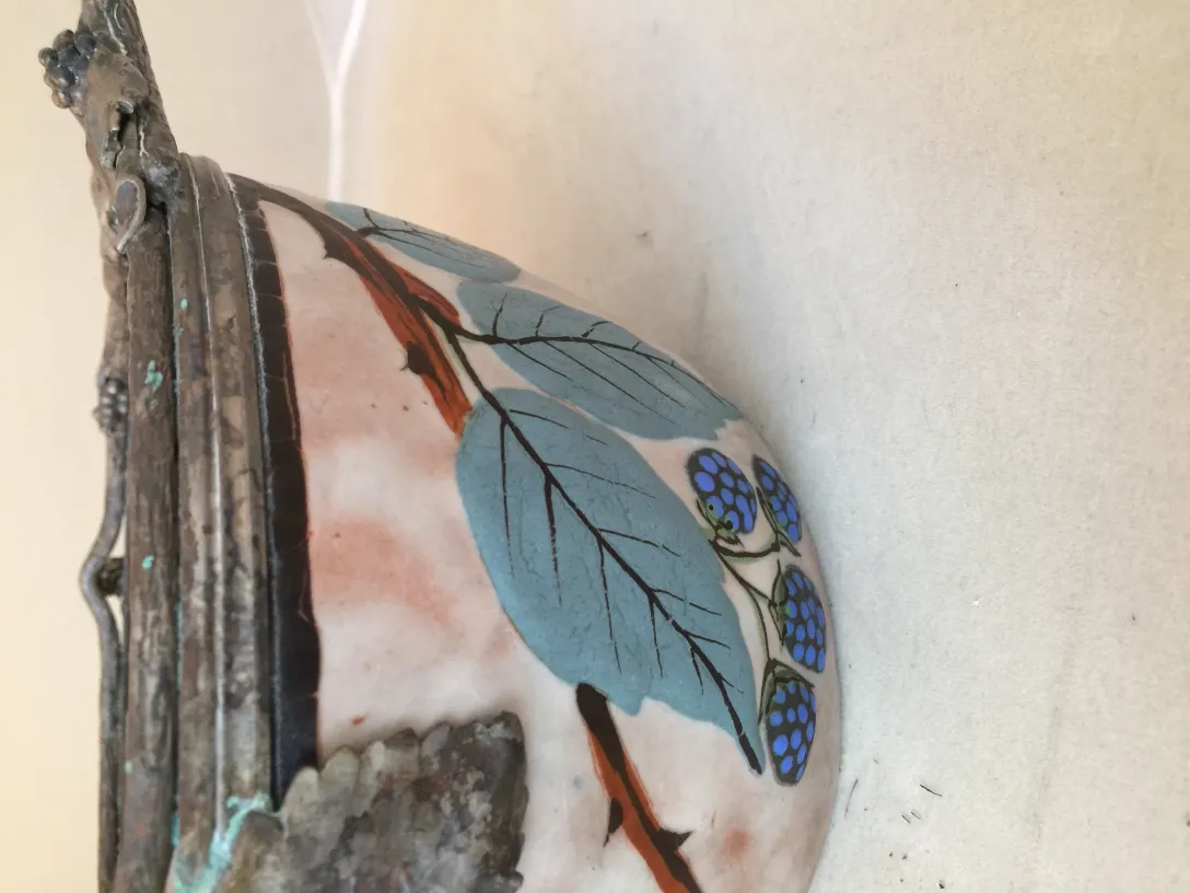 Antique ceramic featuring green leaves and blue berries
