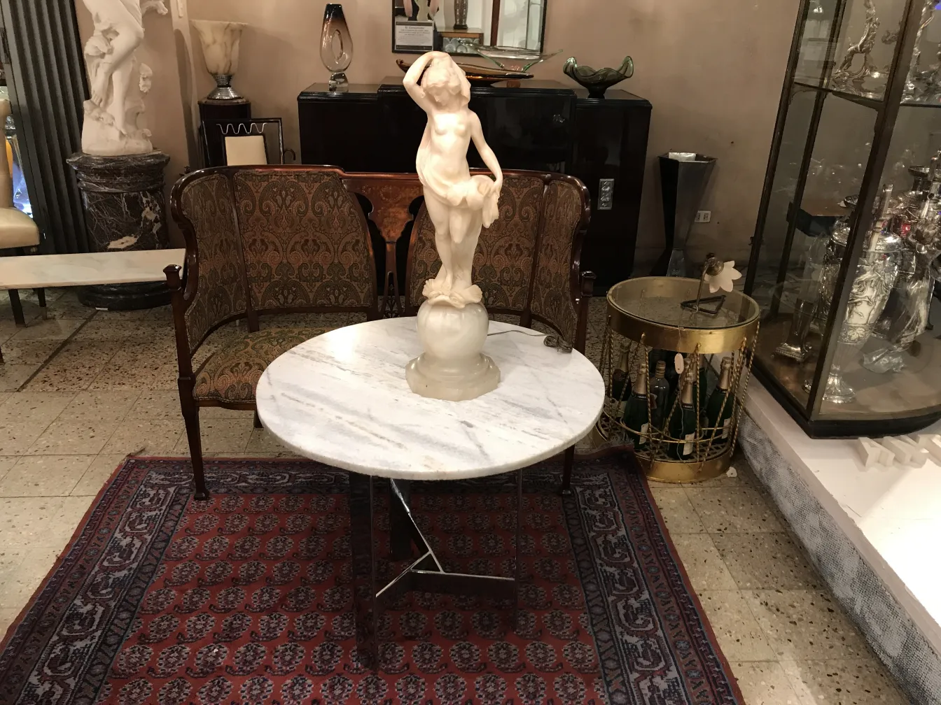 Antique sculpture of a woman holding a cup, decorative in an elegant setting.