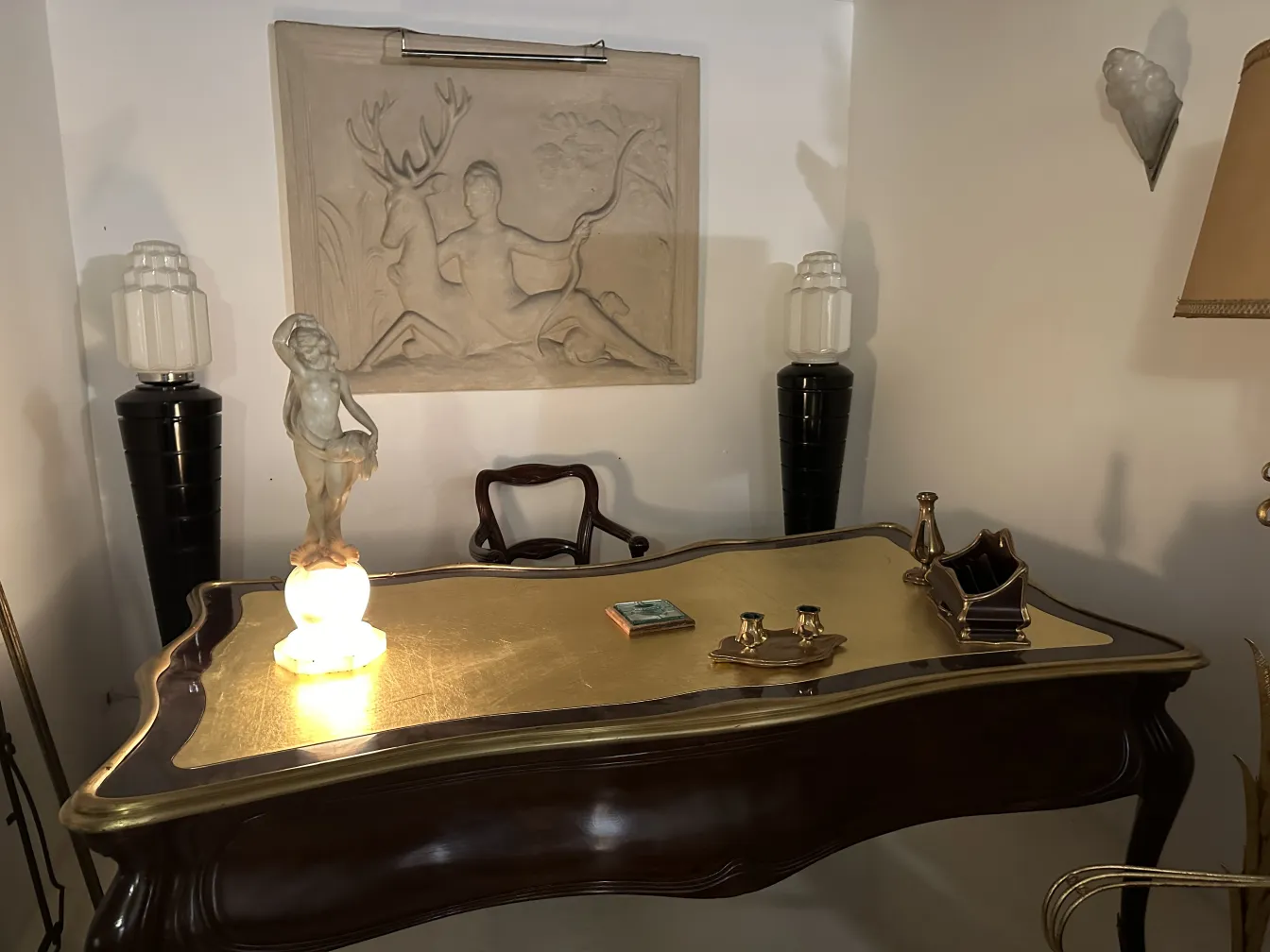 Ancient female figure sculpture on a golden desk