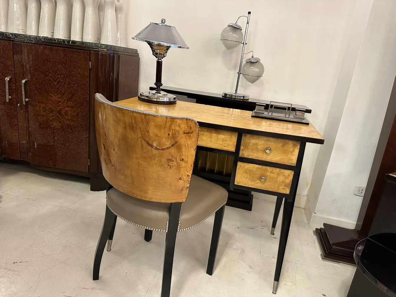 antique desk with lamp and chair in a classic setting