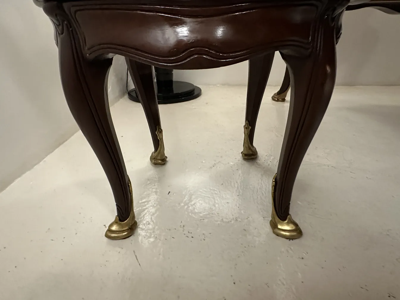 View of the golden legs of the antique desk by Gustave Keller