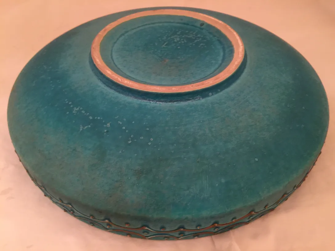 Ancienne céramique bleue foncée avec des détails subtils.