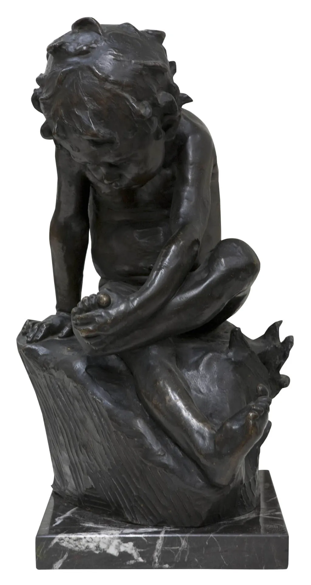 antique sculpture of a seated child with a thoughtful expression