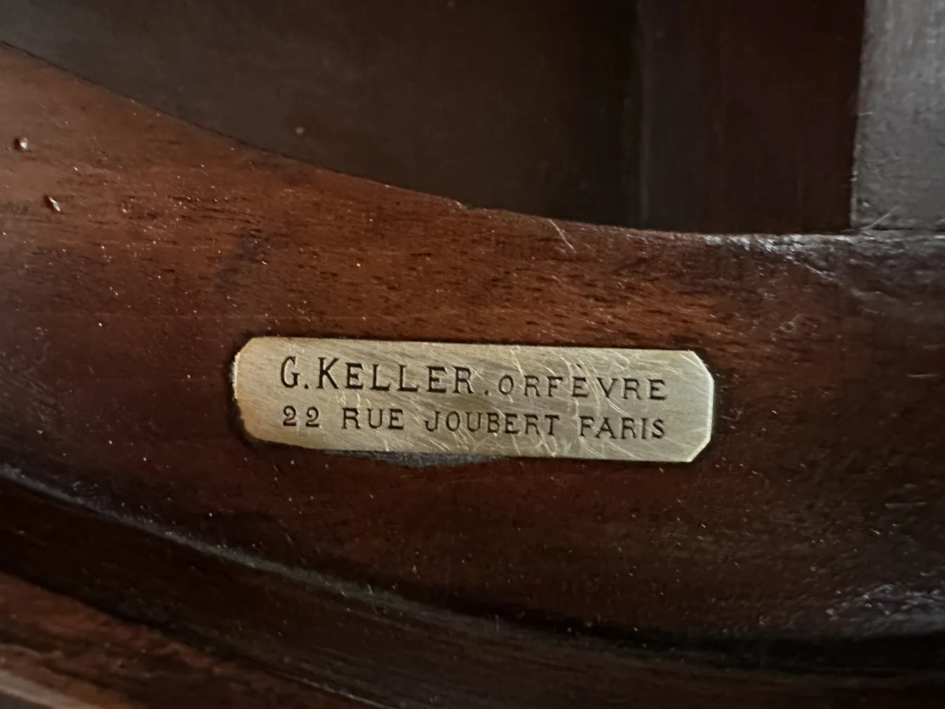Antique desk by Gustave Keller, Orfevre, Paris, featuring a visible tag and surrounding details.