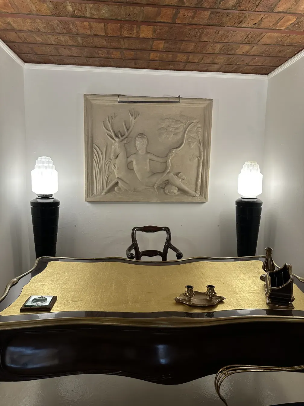 Antique desk by Gustave Keller with elegant decor, in a calm environment.