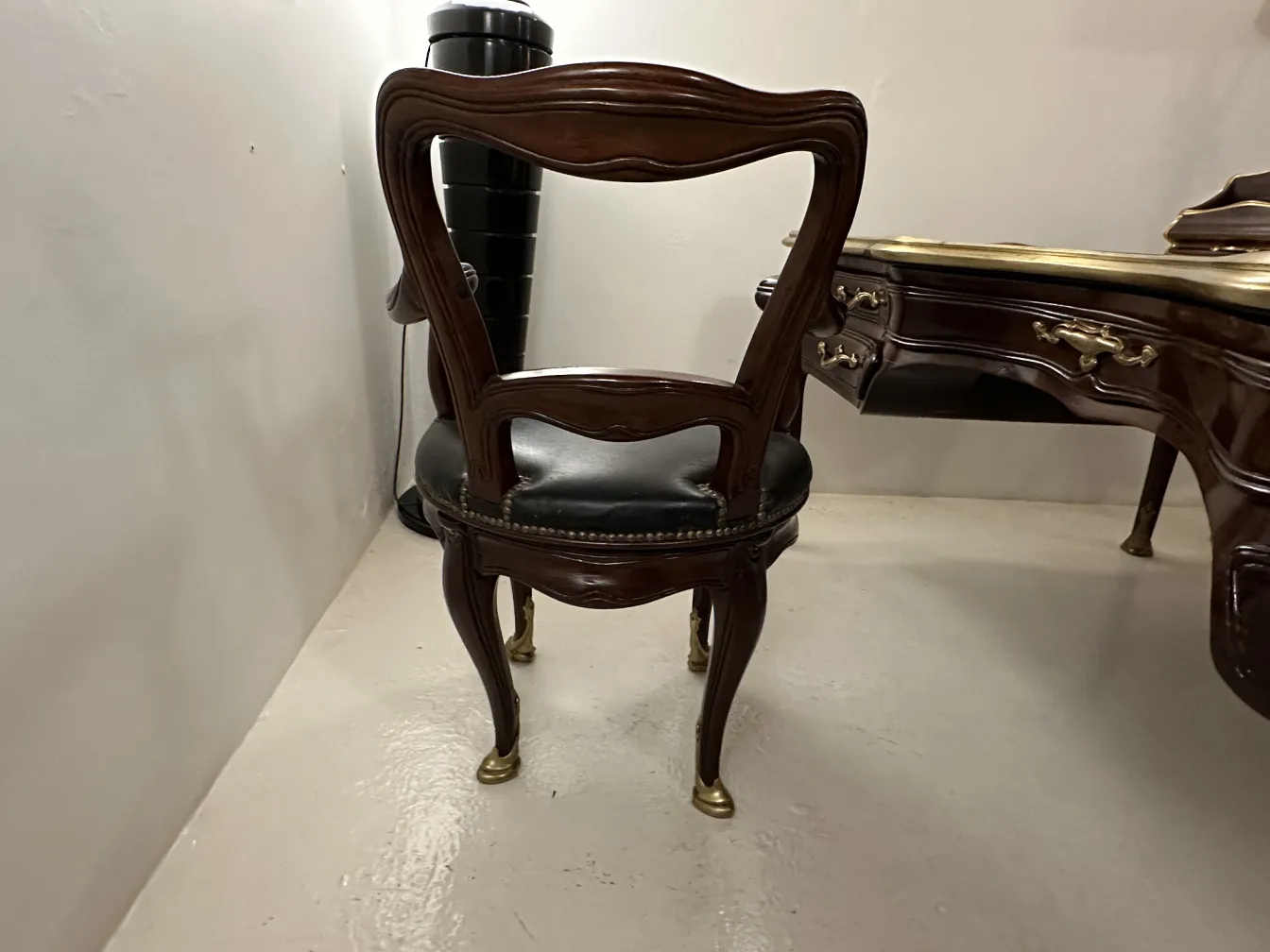 Antique desk by Gustave Keller at 22 rue Joubert, with an elegant chair behind.