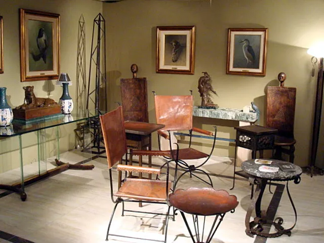 Scultura decorativa antica accanto a mobili e quadri